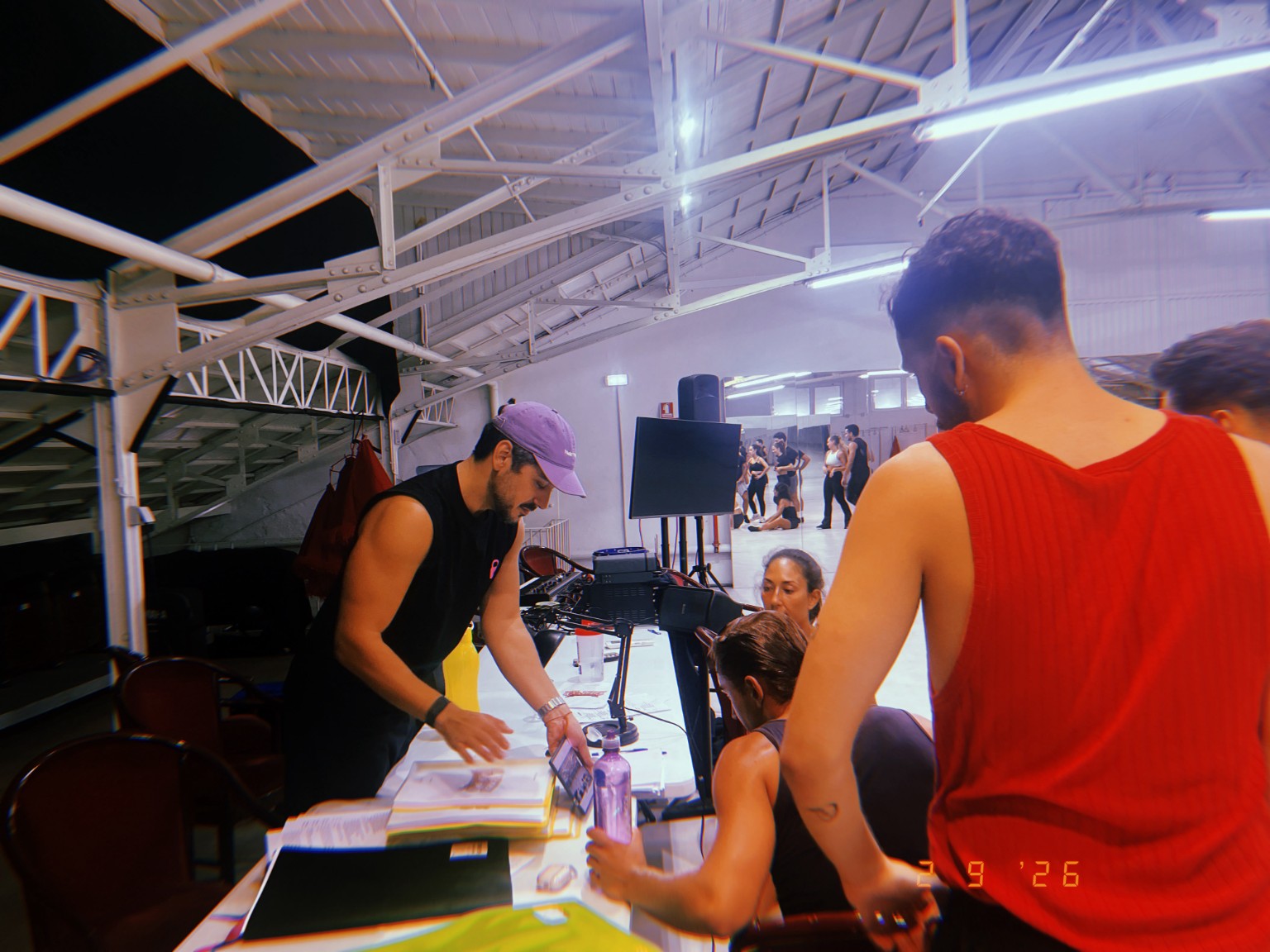 Marco collaborating with performers over the rehearsal materials